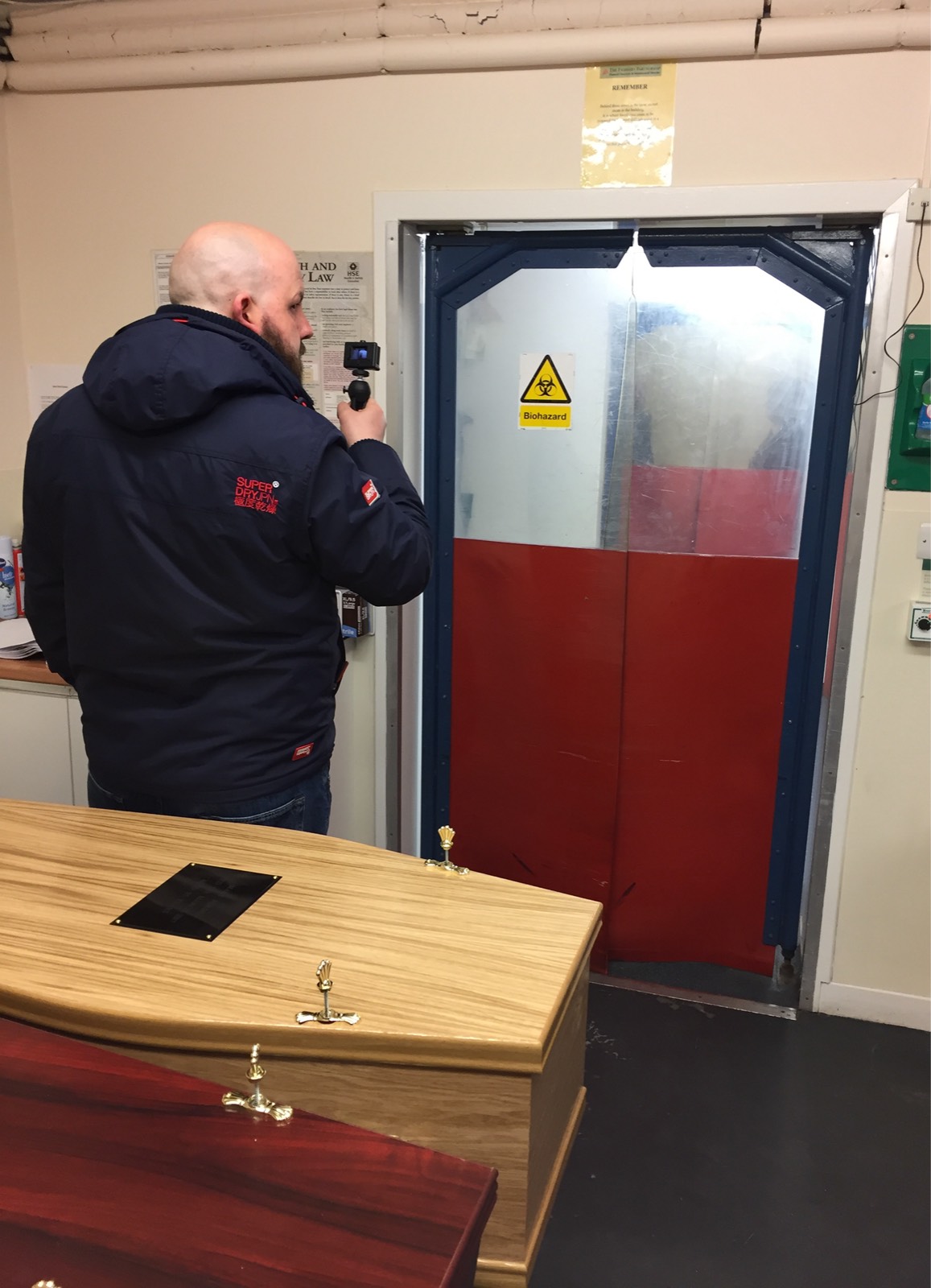 User researcher films the door to the mortuary in a funeral home